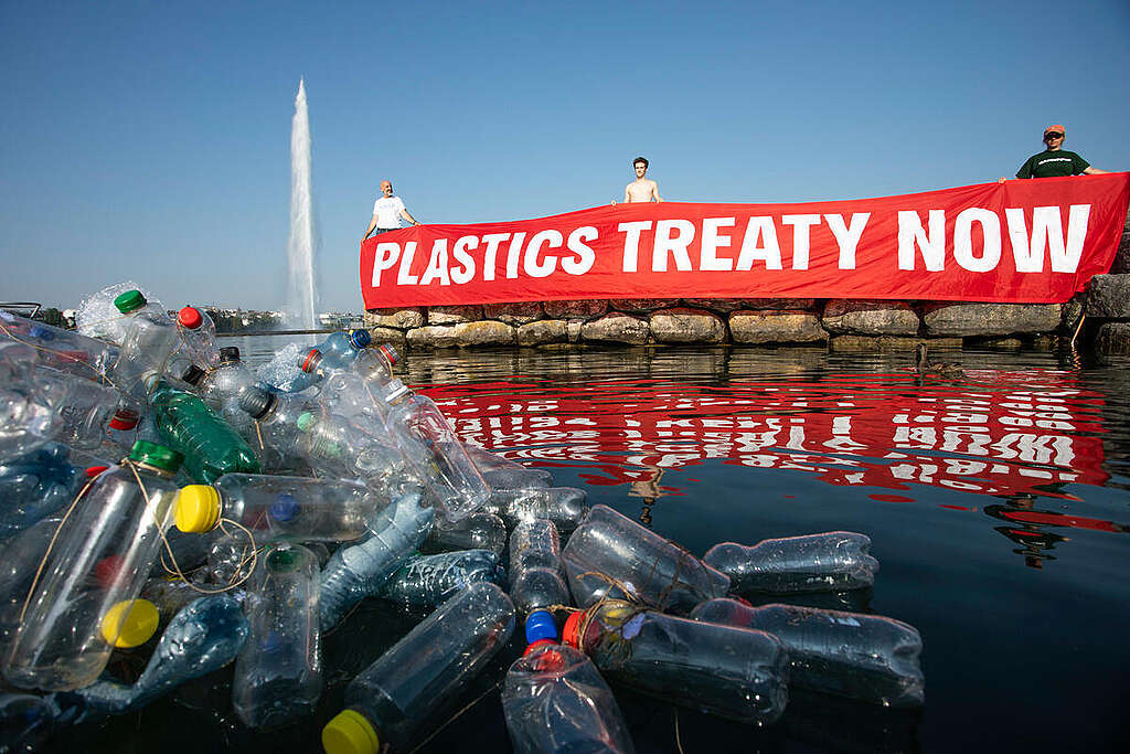 Activists hold up a banner saying 