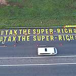 Greenpeace Africa activists painted ‘Tax The Super-Rich’ on a major road leading to Johannesburg Expo Centre, where world leaders are gathering for the start of the G20 Heads of States Summit.