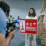 In the 10th anniversary year of the Paris Agreement, Greenpeace constructed an Eiffel Tower replica made up of cardboard boxes with the sign ‘Fragile. Handle With Care’ to symbolise how the 1.5°C limit agreed in Paris is under threat.