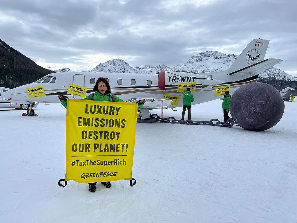 Greenpeace International activists from across Europe symbolically “confiscated” private planes at the Engadin airport in Samedan, Switzerland, which is used by participants of the World Economic Forum (WEF). The peaceful protest marks the last of a series of creative interventions calling policy-makers to tax the super-rich, representing 1% of the world’s population, and redirect tax revenues towards affordable green housing, public transport, and climate and environmental action, to support communities and protect the planet. © Nina Fink / Greenpeace