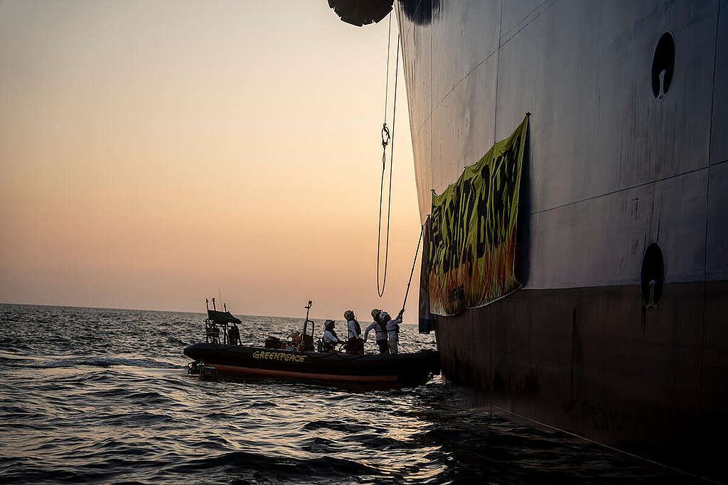 Activists from seven countries participate in an action with Greenpeace Italy against climate-wrecking fossil gas at the new liquefied gas import terminal in Ravenna. At sea, activists reached the infrastructure and attached large banners on it reading 