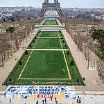 On the occasion of the 10th anniversary of the Paris Agreement, Climate Justice Action, ANV-COP21 and Greenpeace France unfurled a 300-square-meter banner on the Champ-de-Mars in Paris, denouncing 10 years of climate sabotage and showing the faces of Emmanuel Macron, Marine Le Pen, Vincent Bolloré, Patrick Pouyanné, Jeff Bezos and Donald Trump. 
These faces symbolize the different political and private forces that are torpedoing the fight against climate change. These politicians, these leaders of polluting companies and these billionaires represent a destructive system that defends the private interests and profits of a few to the detriment of the protection of populations and especially the most vulnerable in the face of the climate emergency.