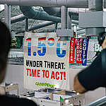 Greenpeace joined other NGOs and allies to participate in a silent banner drop in the Blue Zone, with a banner reading 1.5 Under Threat, Time to Act!