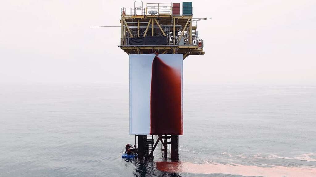 Greenpeace climbers install a major new work by renowned artist Anish Kapoor titled BUTCHERED onto a Shell platform in the North Sea - the world's first artwork to be installed at an active offshore gas site. After securing a giant 12m x 8m canvas to one side of the structure, the activists hoisted a high-pressure hose on top of the canvas at a height of 16 metres above the sea. They then pumped 1,000 litres of blood-red liquid that gushed into the fabric, creating a vast crimson stain. The work is a stark visualisation of the wound inflicted on both humanity and the Earth by the fossil fuel industry, evocative of our collective grief and pain at what has been lost, but also a cry for reparation. &copy; Greenpeace