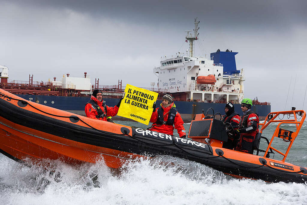On the third annual day of Russia starting the war against Ukraine, fifteen Greenpeace activists protest against environmentally damaging Russian oil exports using run-down tankers from the so-called shadow fleet on the Baltic Sea off Rostock. From inflatable boats, the Polish, Swedish, Danish Ukrainian and German environmentalists painted 'RISK!' in large yellow letters on the tankers' side as the 'Prosperity' passed by. &copy; Lucas Wahl / Greenpeace