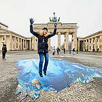 Greenpeace celebrates the imminent entry into force of the historic UN High Seas Protection Agreement (BBNJ) with an art event in front of the Brandenburg Gate. Greenpeace activists lay out a 5 x 8 metre 3D floor banner that transforms the square into a colourful underwater world. The agreement will enter into force worldwide on 17 January 2026. Ratification by Germany is still pending. 
Seen here: Greenpeace Campaigner Ocean Protection Franziska Saalmann.