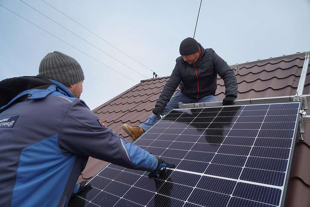 Fitting solar panels on roof of a War-Torn Hospital in Ukraine as part of green reconstruction efforts. &copy; Oleksandr Popenko / Greenpeace