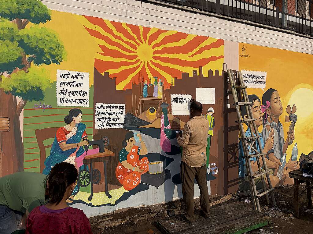 Artists painting mural