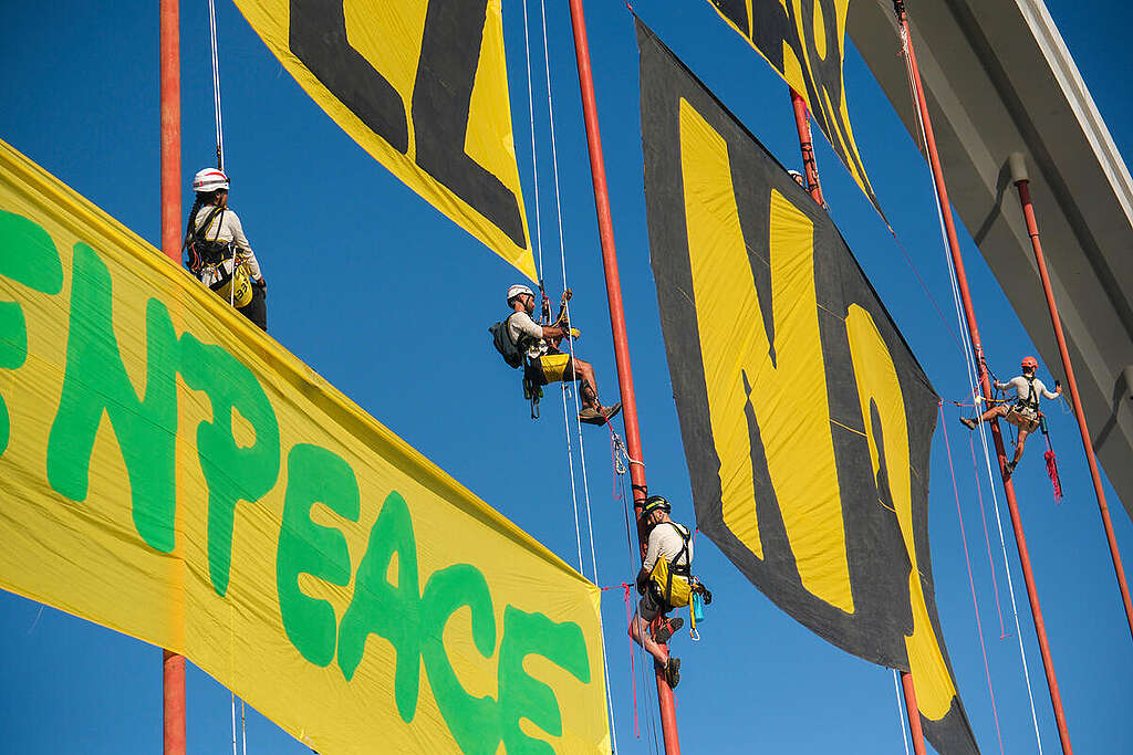 About thirty Greenpeace Spain activists unfurled a huge banner on the Barqueta Bridge in Seville bearing the slogan 
