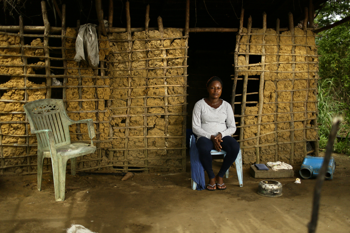 Bagyeli Community Leader in Cameroon Solange Sanhgan, 29 years old, a leader of the Bagyeli community sits in front of her mother's kitchen.