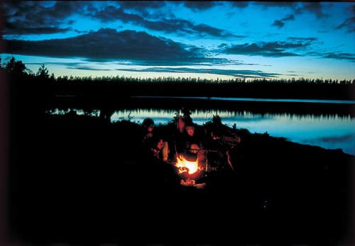 Magic evening at a campfire in the Rogen area, Finland.    Planet der Walder page 62.