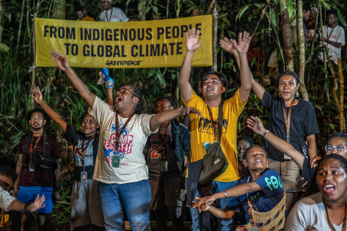 The 2nd Forest Defender Camp 2025 in Papua Day 3 Participants watch the performance during the Forest Defender Camp 2025 in the Sira village forest, at Knasaimos customary area in South Sorong, Southwest Papua. Greenpeace Indonesia holds the second Forest Defender Camp (FDC) from 23-26 September 2025 in Sira's customary forest of Tehit Tribe Knasaimos area, South Sorong, South West Papua. The FDC is attended by 89 participants, including Papuan Indigenous youths from 7 customary areas around Papua Island, as well as delegations of Indigenous Peoples from the Congo Basin, Amazon, and Borneo.