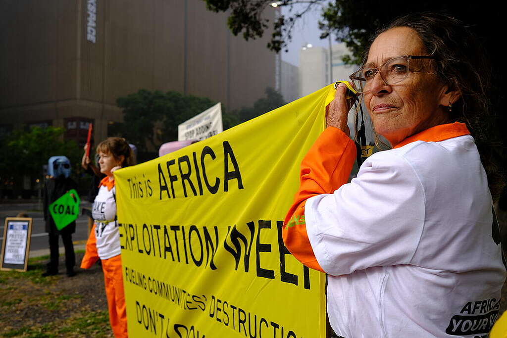 Greenpeace Africa's NVDA (Non-Violent Direct Action) during the African Energy Week, in Cape Town, South Africa. Following reports that fossil fuel companies had created their own wine labelled 'Drill Baby Drill', Greenpeace Africa brought their own drinks to the party with a giant bottle named 'Pay Baby Pay'.The conference is a forum where oil and gas companies and interests gather to discuss the promotion of fossil fuel investments instead of alternatives and renewable energy