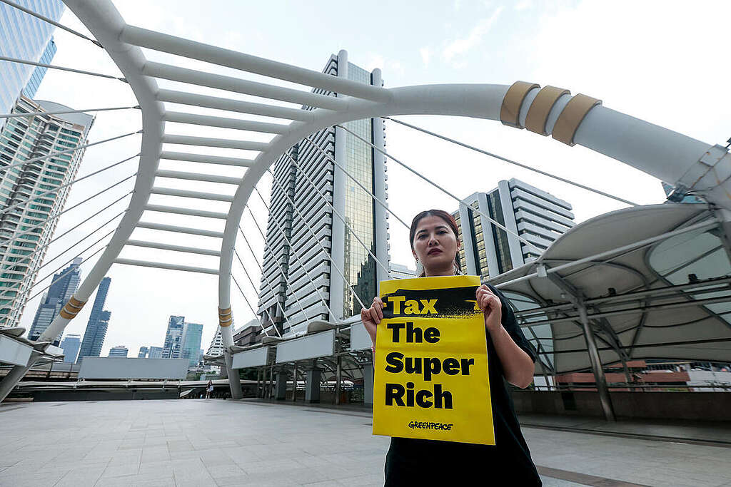 During the IMF-World Bank Group Annual Meetings 2026 (Oct 12-18) in Bangkok, Greenpeace Thailand activists called for economic and climate justice. Action took place in Bangkok's business district with signs and shirts demanding 