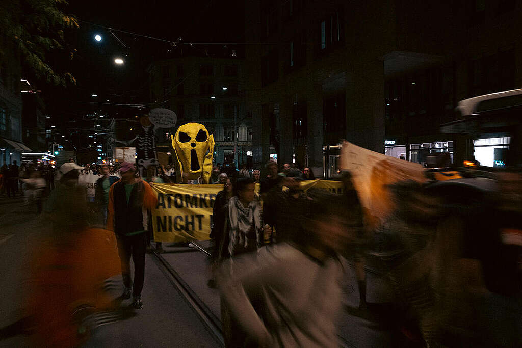 Greenpeace is marching through Zurich alongside approximately 7,000 other people, calling for 