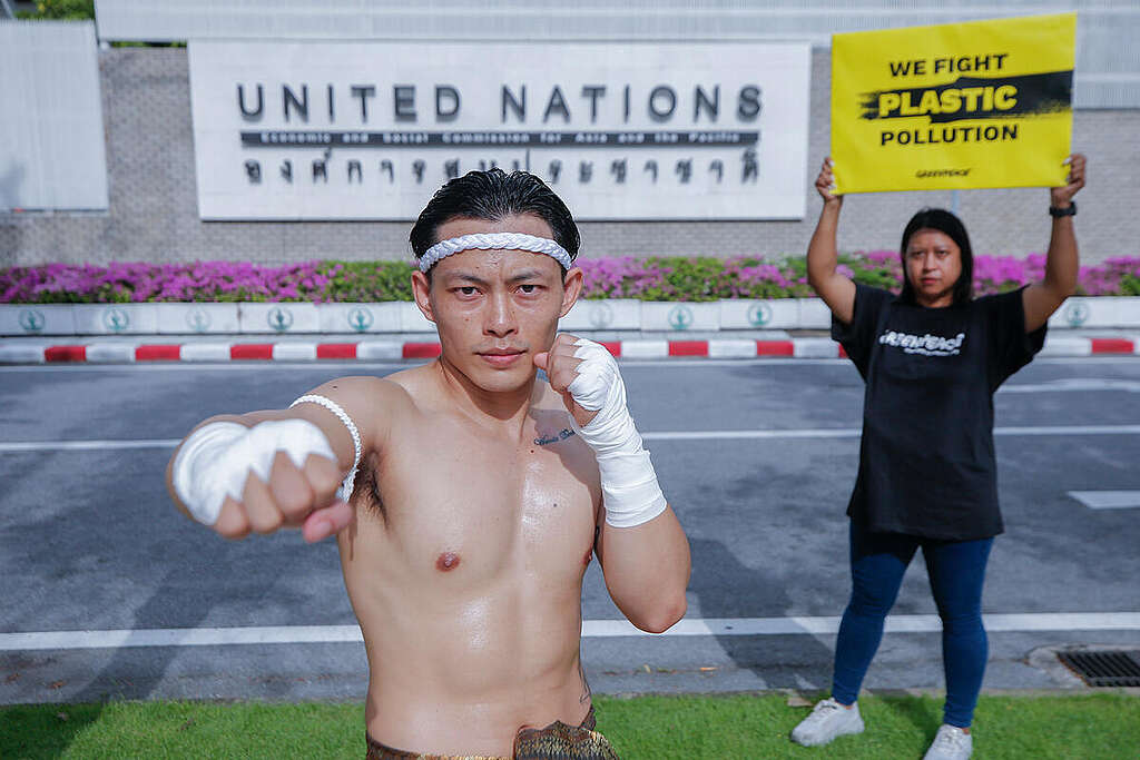 Greenpeace Thailand activists with a Muay Thai fighter stage a symbolic action outside the United Nations office in Bangkok, where Heads of Delegation (HODs) from Member States meet. The action symbolises the need to 