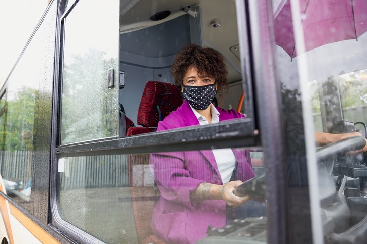 Public transport worker wearing a face mask and working during the Covid crisis.