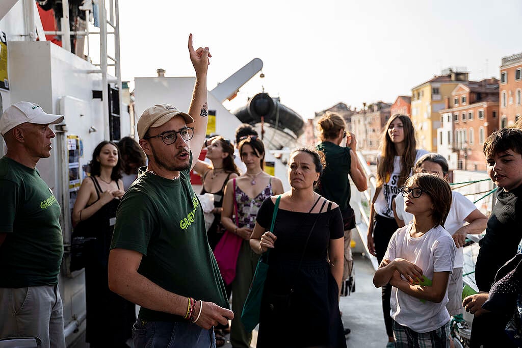 Volontari e volontarie di Greenpeace accompagnano le persone durante una visita guidata a bordo della nave Arctic Sunrise