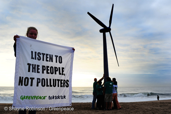 Greenpeace volunteers raise a wind turbine on the beach at dawn in Durban, South Africa, to send a message of hope for the latest round of UN climate change talks opening here on Monday. Caimpaigners say Durban must be a new dawn for the international negotiations to a gree a fair, ambitious nad legally binding treaty to avert climate chaos. They are demanding that politicians stop listening to the pollouting coroprations and listen to the people who want an end to our dependence on fossil fuels. Africa is on the front line of dangerous climate change, with millions already suffering the impacts through increased drought and extreme weather events, threatening lives abd food security.Picture: Shayne Robinson, Greenpeace