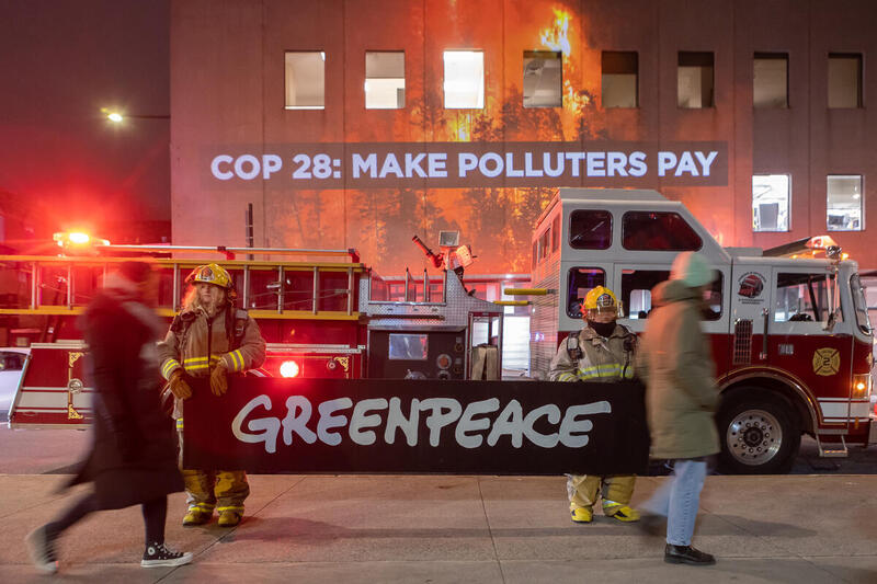 Greenpeace Canada projects Make Polluters Pay on Canada’s Environment Minister’s office in Montreal as COP28 begins