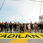A group of Greenpeace volunteers and ship crew members call for stronger environmental protection on the Rainbow Warrior's helideck with a 'Keadilan Iklim' or Climate Justice banner at Port Klang, Selangor, Malaysia.