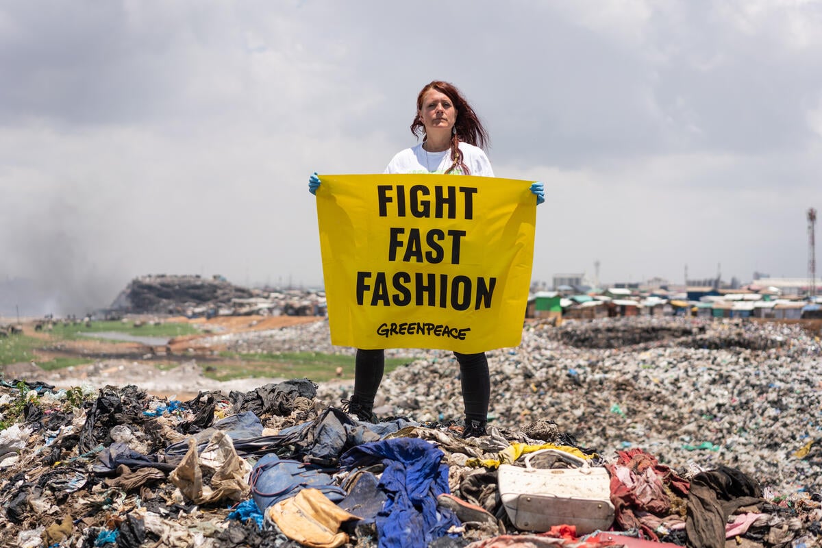 Fast Fashion and Waste Colonialism - Banner at Dumpsite in Ghana. © Kevin McElvaney / Greenpeace