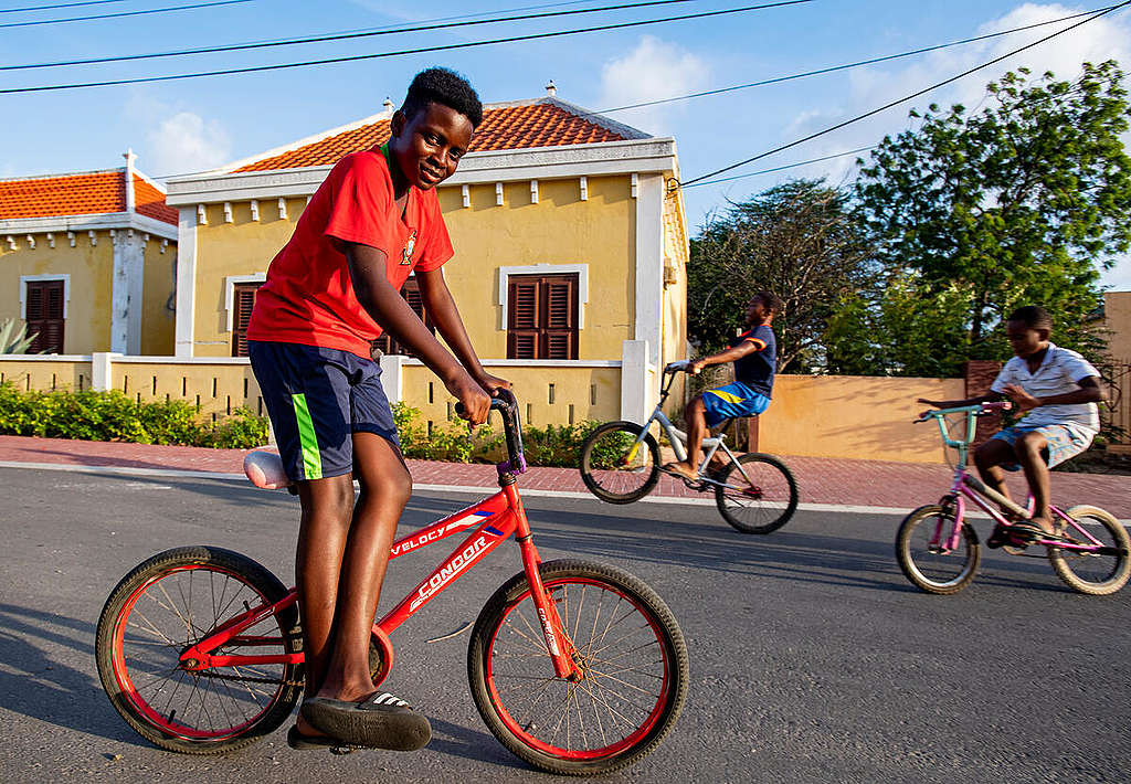 Local Kids on their Bikes on Bonaire. © Marten van Dijl / Greenpeace Local Kids on their Bikes on Bonaire. © Marten van Dijl / Greenpeace