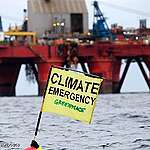 Greenpeace campaigner Sarah North holds a banner reading "Climate Emergency" whilst floating in front of BP oil rig on day 11 of the protest in the North Sea.
Greenpeace is calling on BP to halt drilling for new oil in light of the climate emergency and refocus their business on renewable energy.