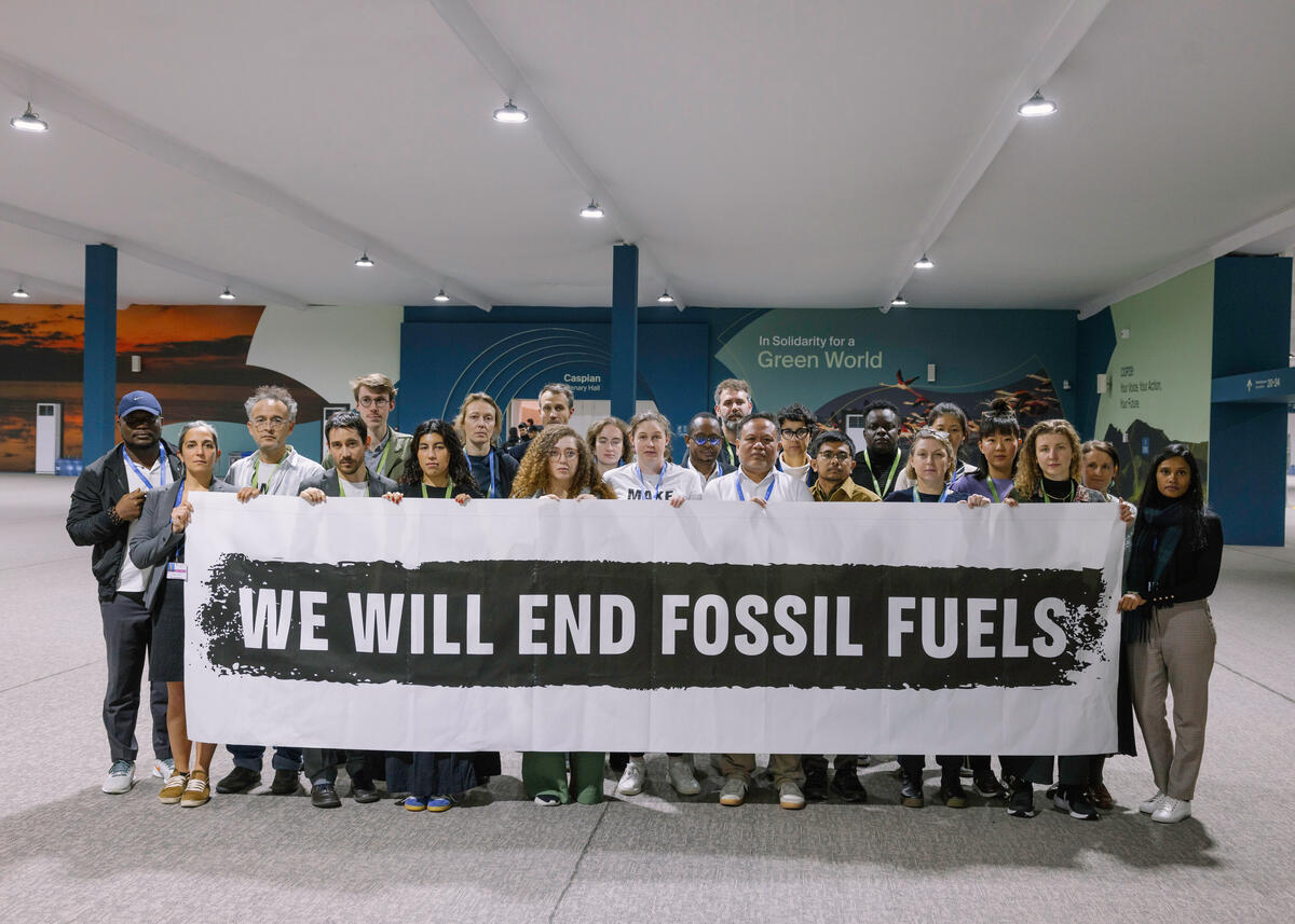 "We Will End Fossil Fuels" Banner at COP29 in Baku. © Marie Jacquemin / Greenpeace
