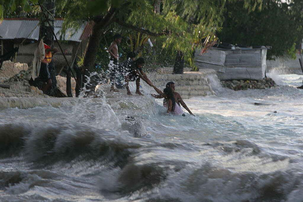 Kiribati King Tides Flooding Documentation Villagers living next to the sea pull themselves from the high waves caused by the 'King Tides', waves peak at 2.87 metres on the fragile atoll, Betio village, Tarawa Island, Kiribati, South Pacific. Greenpeace and scientists are concerned that low-lying islands face permanent inundation from rising seas due to climate change.