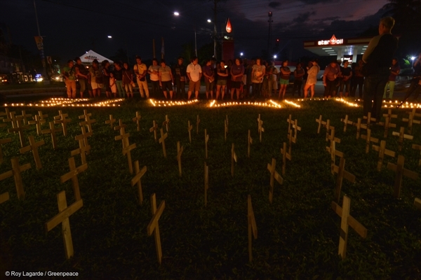 On the eve of the Super Typhoon Haiyan's 3rd year anniversary, people from Tacloban light a candle that spells out "Climate Justice" to commemorate the devastating landfall three years ago. 