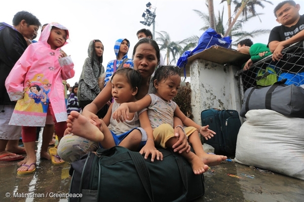 Tacloban City residents wait at the airport as they try to get a seat on outgoing C130 planes bound to Manila. Supplies have been scarce particularly water for the last four days and many are wanting to leave the city. 
