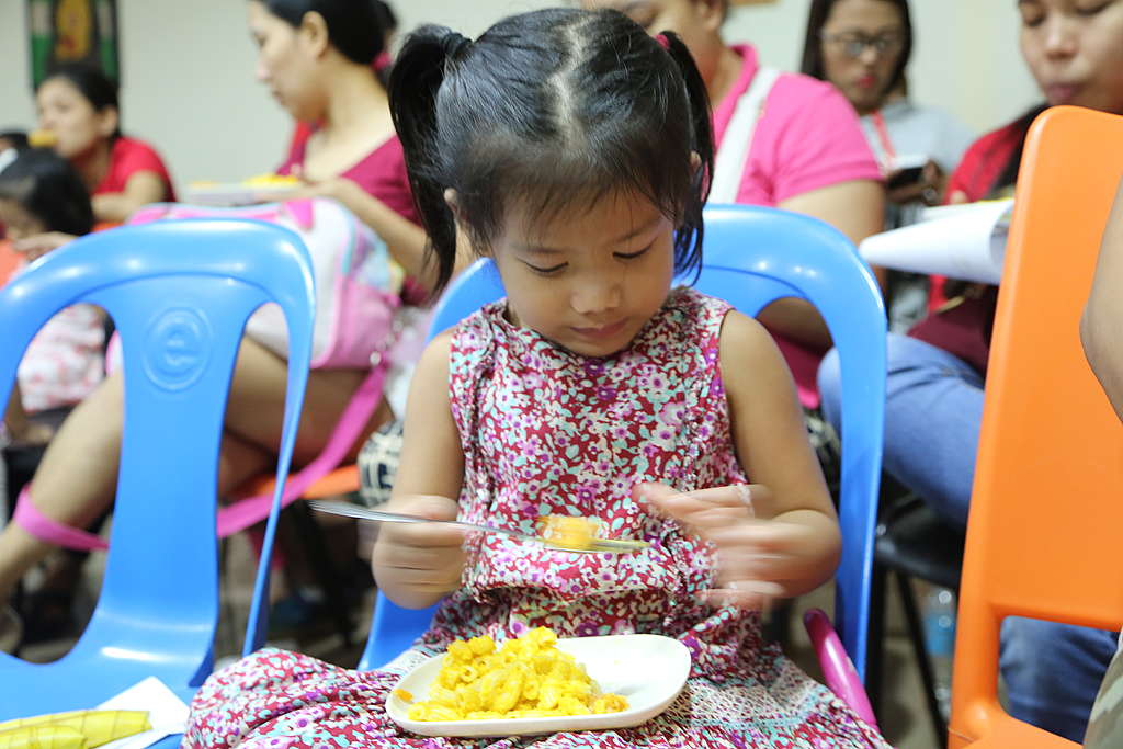 Young girl eating mac & squash