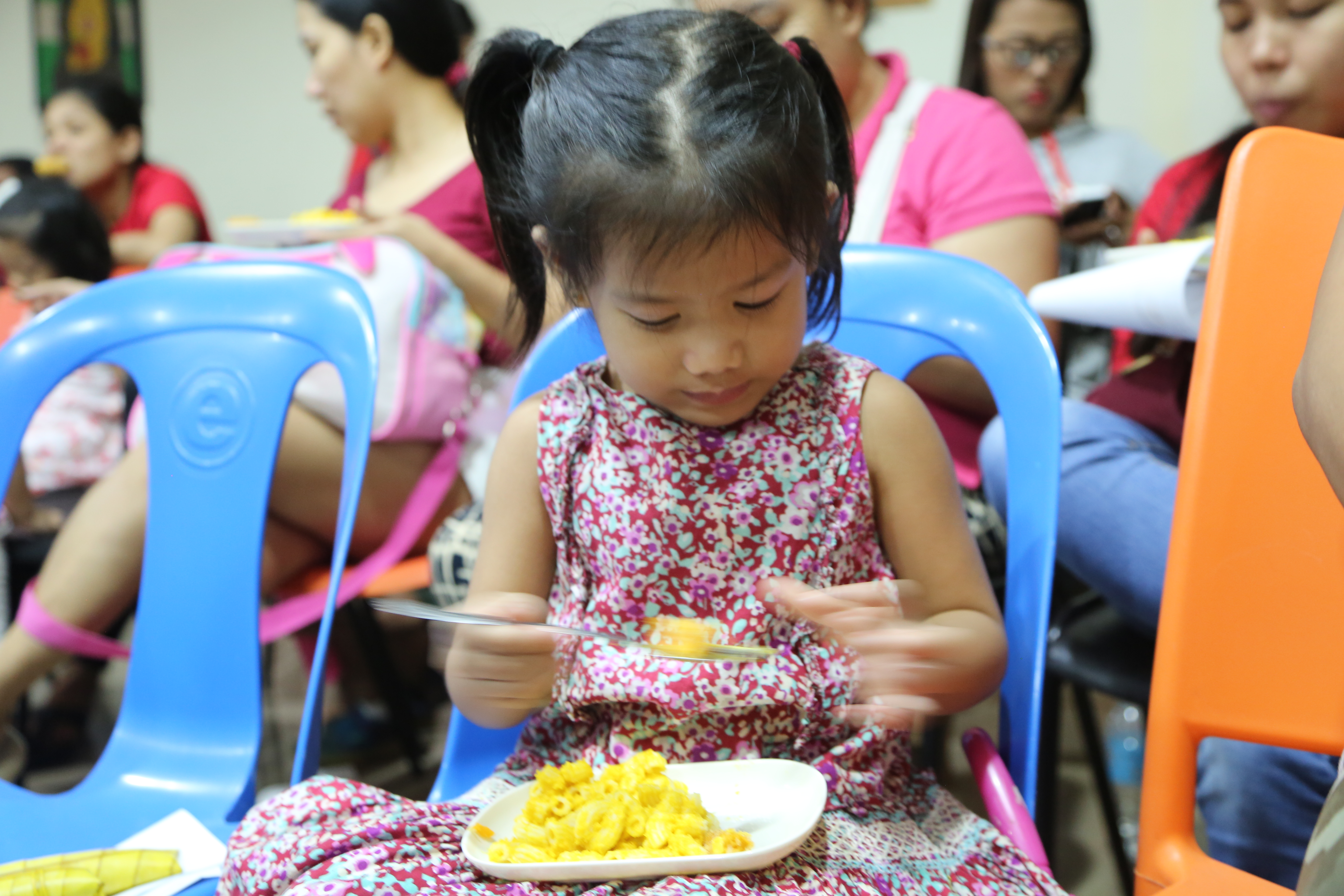 Young girl eating mac & squash