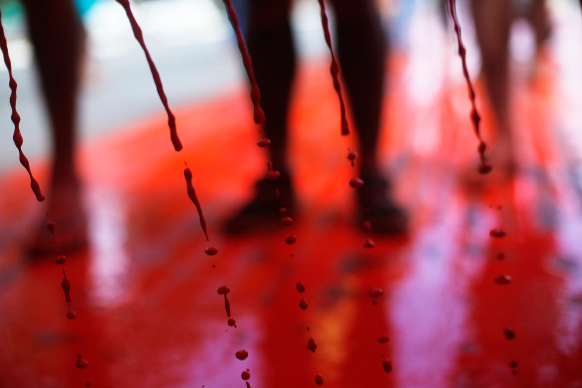 Indigenous People Protest with "Blood" Trail in Brazil. © Adriano Machado / MNI