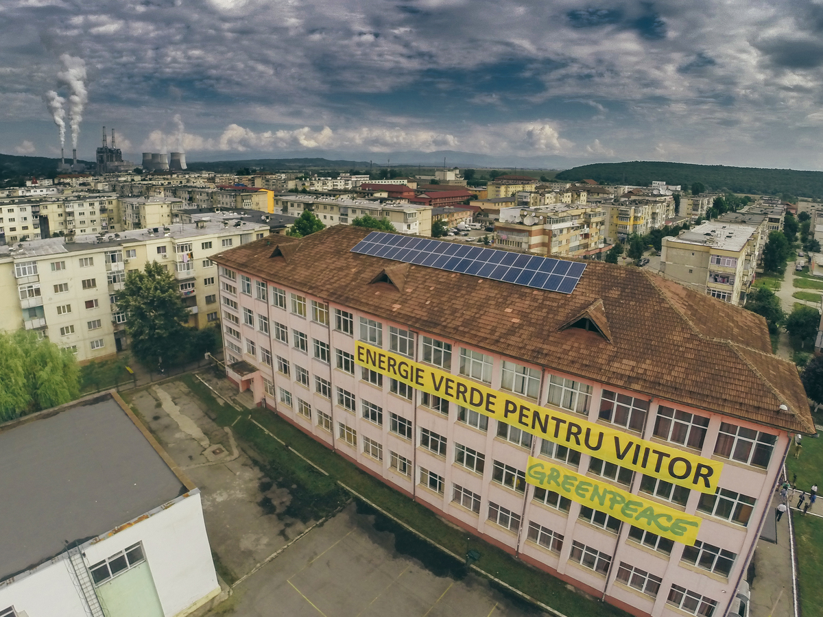 Installation of Solar Panels on School Rooftop in Romania. © Cristian Grecu / Greenpeace