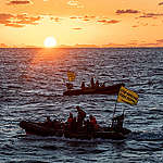 Activists and rhibs. © Chris J Ratcliffe / Greenpeace