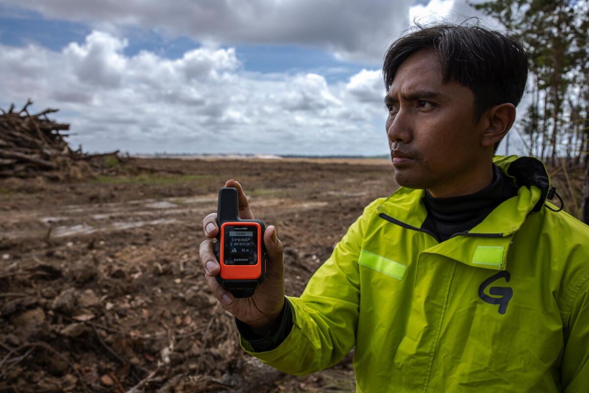 Refki Saputra in PT Greenpeace Indonesia’s Forest Campaigner Refki Saputra, shows a GPS coordinate of forest clearance and sugarcane plantation development in PT. Global Papua Abadi (GPA) in Senayu village, Sermayam district, Merauke regency, South Papua province on September 18, 2025.