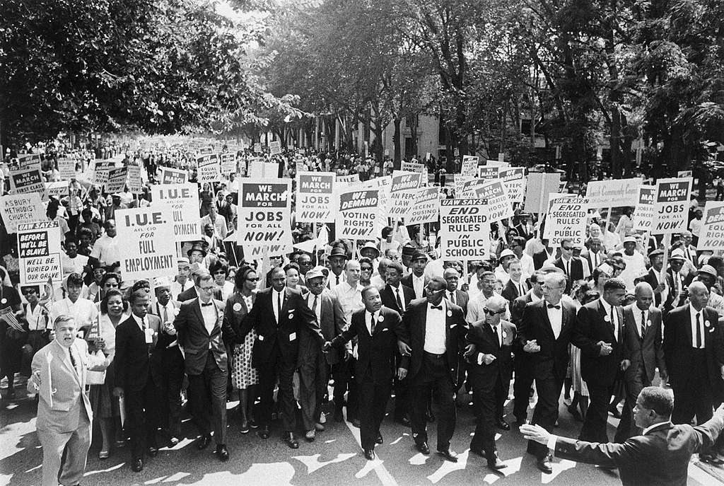 (Original Caption) 8/29/1963-Washington, D.C.- Leaders of the March on Washington lock arms and put hands together as they move along Constitution Avenue here Aug. 28. A. Philip Randolph, march director, is at right, and Roy Wilkins, Executive Secretary of the National Association for the Advancement of Colored People (NAACP), is second from right. The Rev. Martin Luther King, Jr., is seventh from right. (Original Caption) 8/29/1963-Washington, D.C.- Leaders of the March on Washington lock arms and put hands together as they move along Constitution Avenue here Aug. 28. A. Philip Randolph, march director, is at right, and Roy Wilkins, Executive Secretary of the National Association for the Advancement of Colored People (NAACP), is second from right. The Rev. Martin Luther King, Jr., is seventh from right.