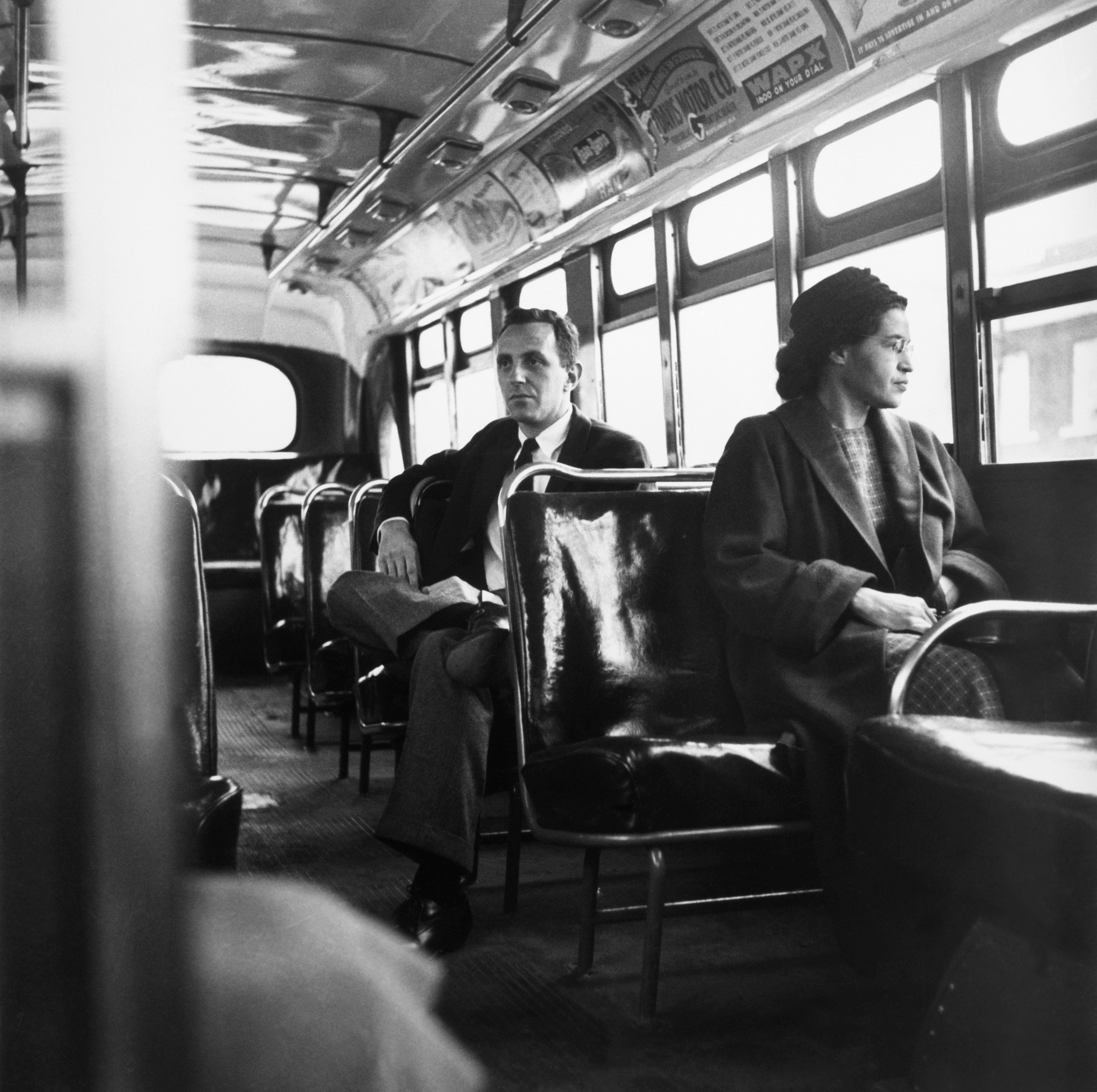 B&W Photo of Rosa Parks sits in the front of a bus in Montgomery, Alabama, after the Supreme Court ruled segregation illegal on the city bus system on December 21st, 1956. Parks was arrested on December 1, 1955 for refusing to give up her seat in the front of a bus in Montgomery set off a successful boycott of the city busses. Man sitting behind Parks is Nicholas C. Chriss, a reporter for United Press International out of Atlanta. B&W Photo of Rosa Parks sits in the front of a bus in Montgomery, Alabama, after the Supreme Court ruled segregation illegal on the city bus system on December 21st, 1956. Parks was arrested on December 1, 1955 for refusing to give up her seat in the front of a bus in Montgomery set off a successful boycott of the city busses. Man sitting behind Parks is Nicholas C. Chriss, a reporter for United Press International out of Atlanta.
