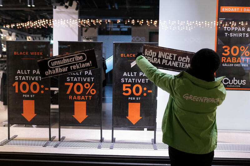 Greenpeace protesterar mot konsumtionshetsen under Black Friday, centrala Stockholm, år 2020. 