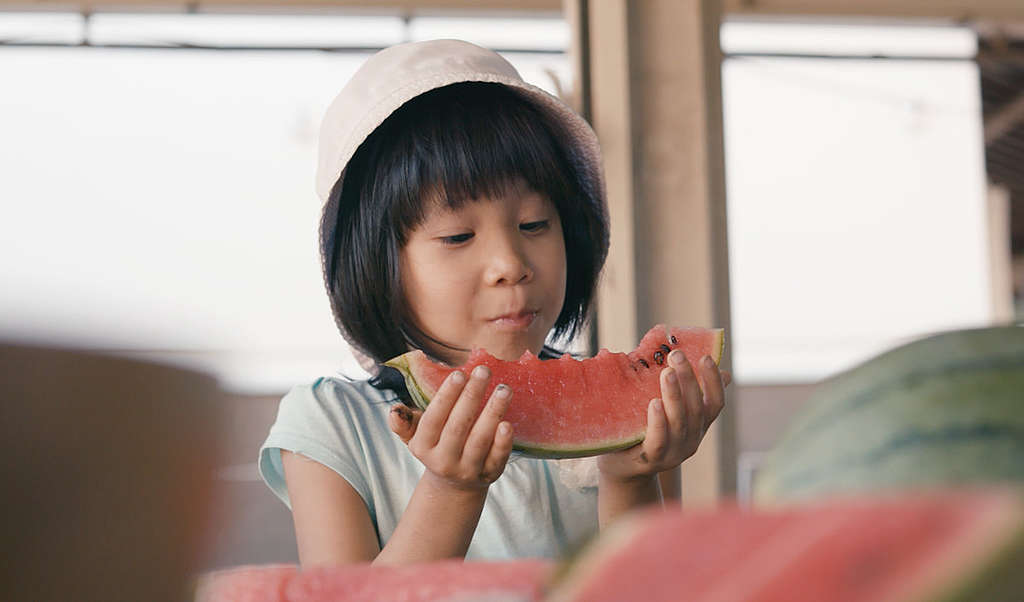 Child Eating Ecological Watermelon in Tokyo. © Greenpeace