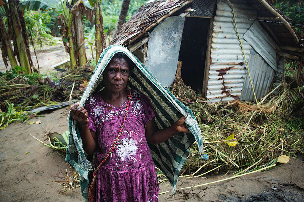 Villager and Severely Damaged Home in Vanuatu.