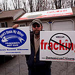 Craig Sautner holds protest signs against hydraulic fracturing (fracking) outside his home in Dimock. He and his wife Julie are suing Cabot Oil & Gas Corp., claiming the energy company's hydraulic fracturing operation near their home contaminated their well in 2008. They have become spokespeople for the anti-fracking movement.