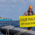 Victor Pickering, a Greenpeace International activist from Fiji  displays a banner reading “Our Pacific Is Not Yours To Destroy” in front of the Maersk Launcher, a ship chartered by DeepGreen, one of the companies spearheading the drive to mine the barely understood deep sea ecosystem.

The Rainbow Warrior is in the Clarion Clipperton Zone in the Pacific to bear witness to the  deep sea mining industry. Part of the ongoing 'Protect the Oceans' campaign.