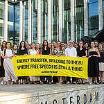 People gather outside the New Amsterdam Courthouse holding a banner reading "Energy Transfer, Welcome To The EU Where Free Speech Is Still A Thing" to mark the beginning of Greenpeace International's anti-SLAPP lawsuit against fossil fuel pipeline company Energy Transfer filed in Amsterdam, The Netherlands.