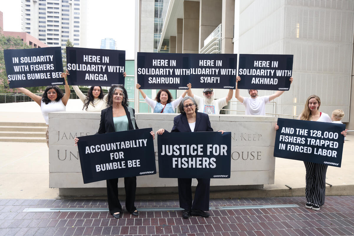 Greenpeace USA activists and the legal team representing four fishermen suing tuna company Bumble Bee over allegations of years of forced labor stand outside the federal courthouse in San Diego, California, following the first hearing in the case.