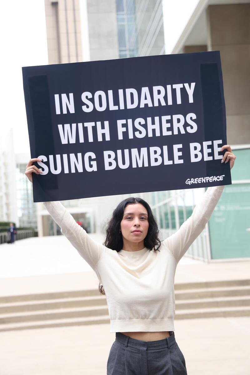 Greenpeace USA activists stand outside the federal courthouse in San Diego, California, in solidarity with four fishermen suing tuna company Bumble Bee over allegations of years of forced labor, as the first hearing in the case takes place inside.