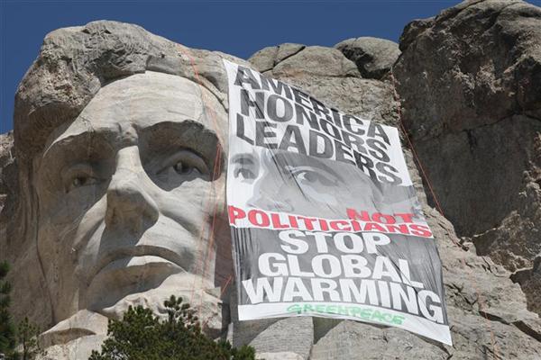 Greenpeace climbers rappel down the face of Mount Rushmore in 2009  to unfurl a banner challenging President Obama to lead on global warming.