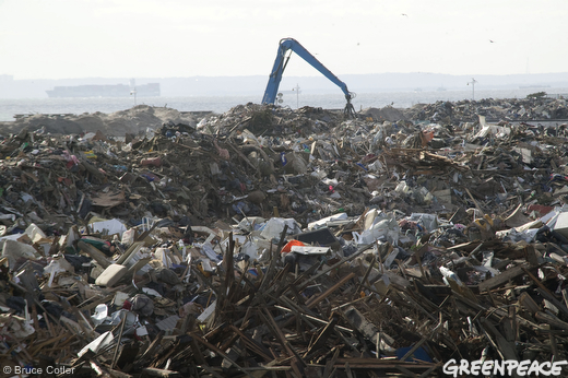 Heavy equipment piles rubble being collected in a makeshift garbage dump in Jacob Riis Park in Rockaway, Queens,